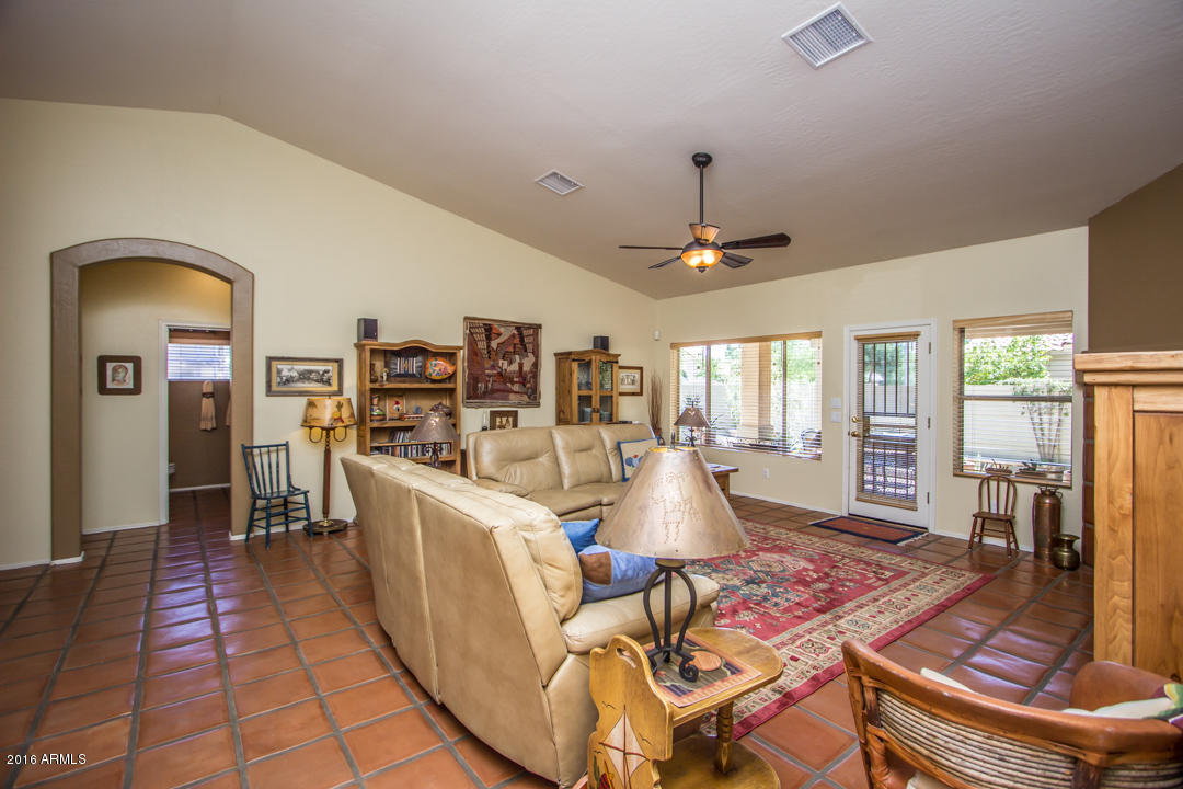 923 East Redfield Road Phoenix, AZ 85022 - Photo 4 of 42 a living room with furniture a dining table and large windows