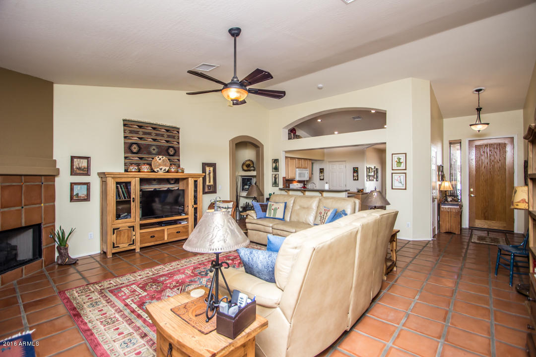 923 East Redfield Road Phoenix, AZ 85022 - Photo 6 of 42 a living room with furniture a fireplace and a flat screen tv