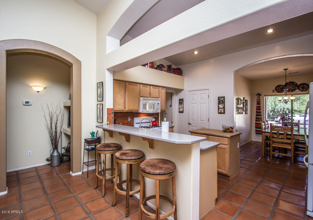 923 East Redfield Road Phoenix, AZ 85022 - Photo 8 of 42 a kitchen with a sink a stove and chairs