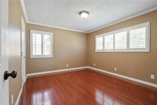a view of a room with wooden floors and window