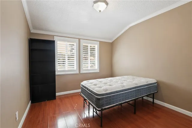 a room with a wooden floor and a window