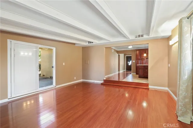 a view of a big room with wooden floor and seating space