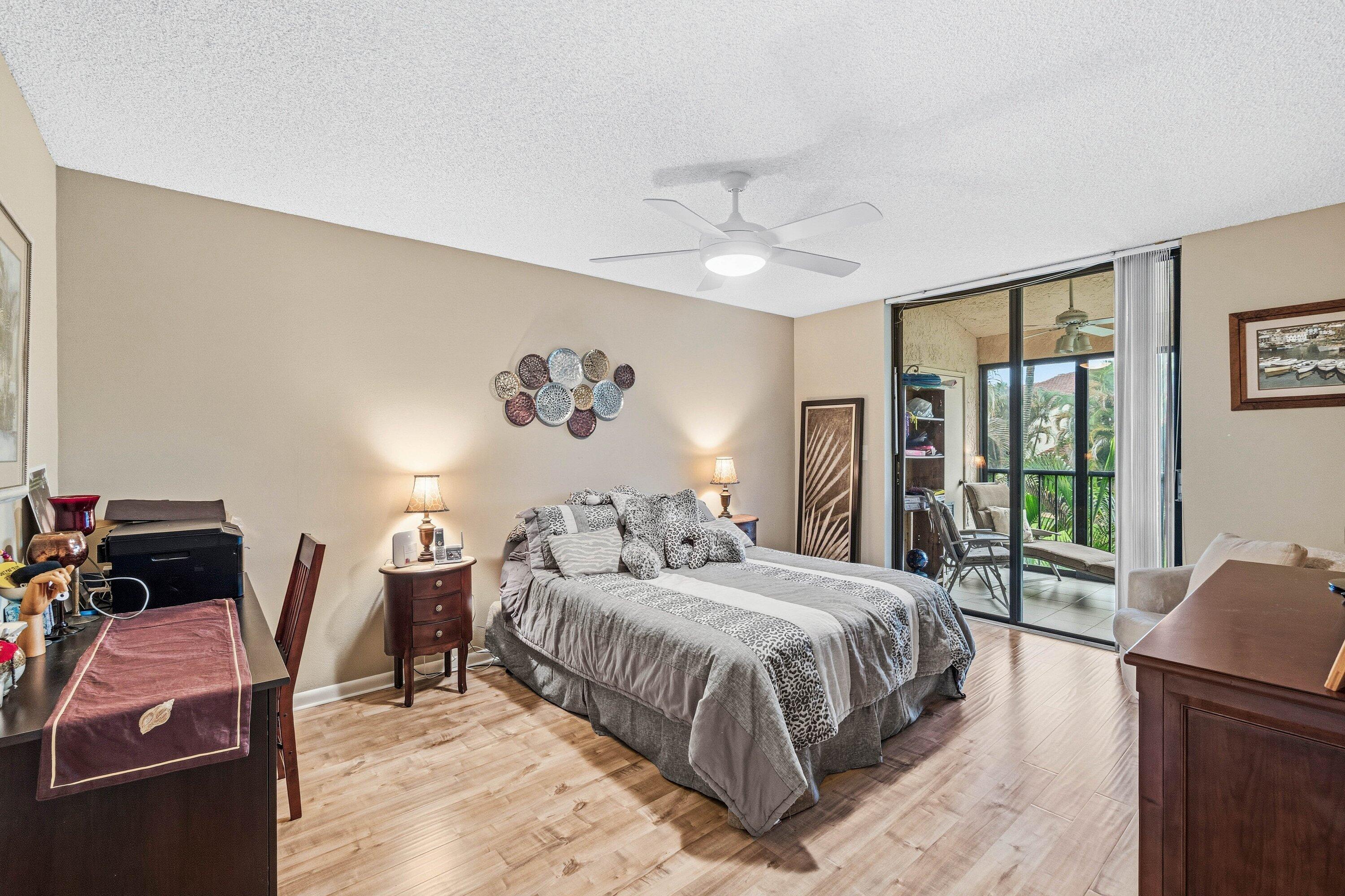 7759 La Mirada Drive Boca Raton, FL 33433 - Photo 19 of 37 a bedroom with a bed and wooden floor