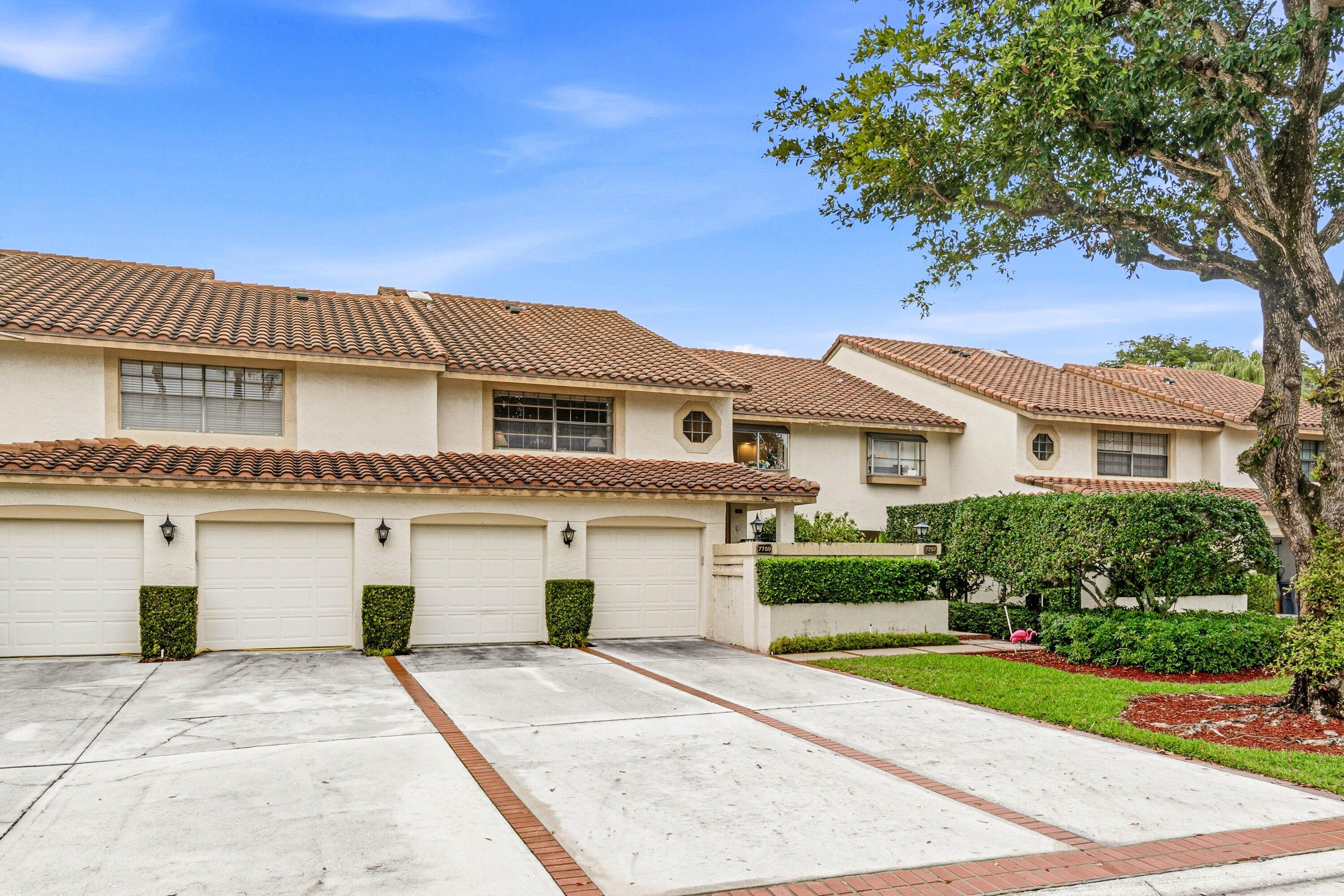 7759 La Mirada Drive Boca Raton, FL 33433 - Photo 2 of 37 a front view of a house with a garden and garage