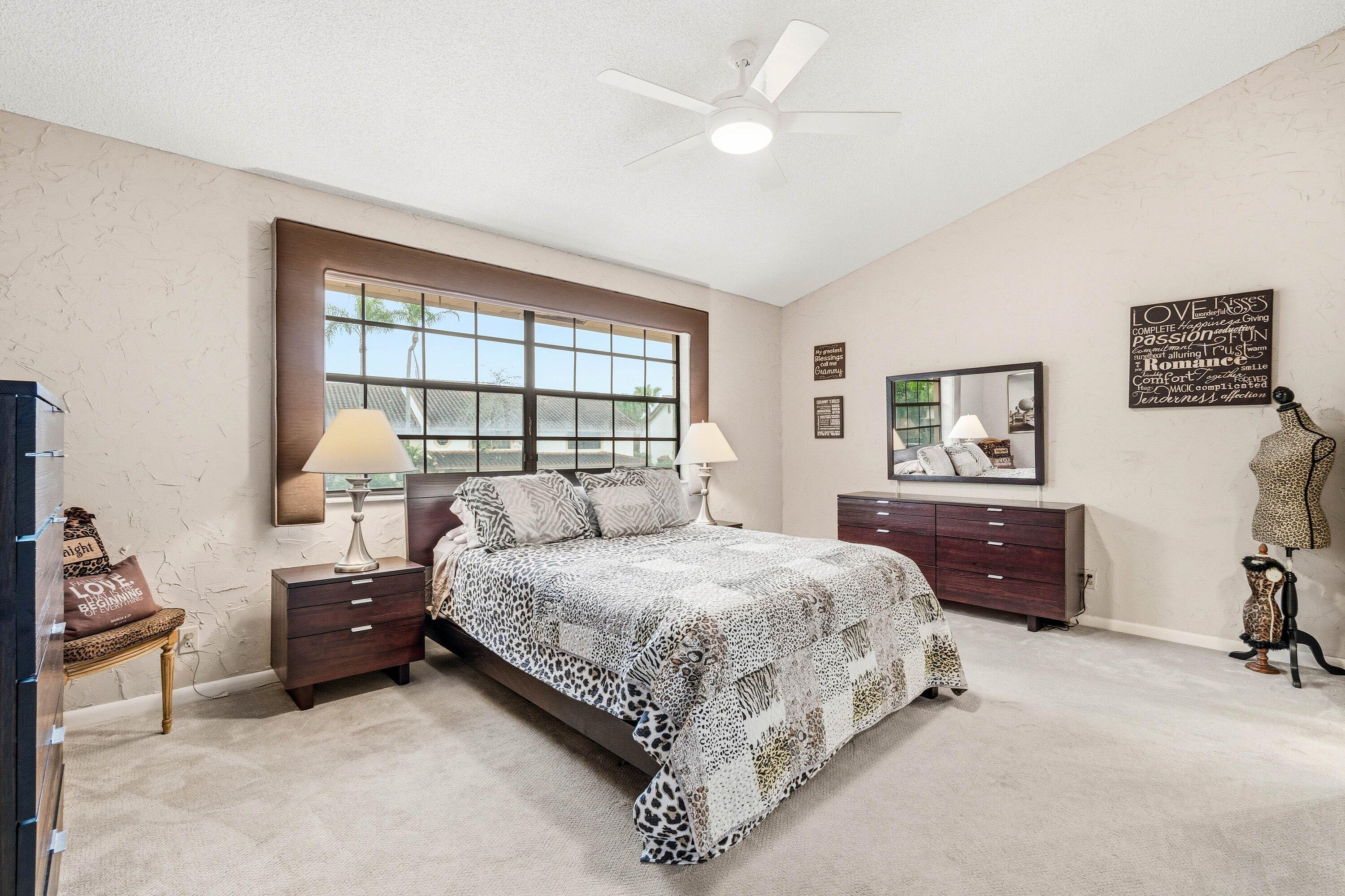 7759 La Mirada Drive Boca Raton, FL 33433 - Photo 21 of 37 a bedroom with a bed and a dresser next to a window