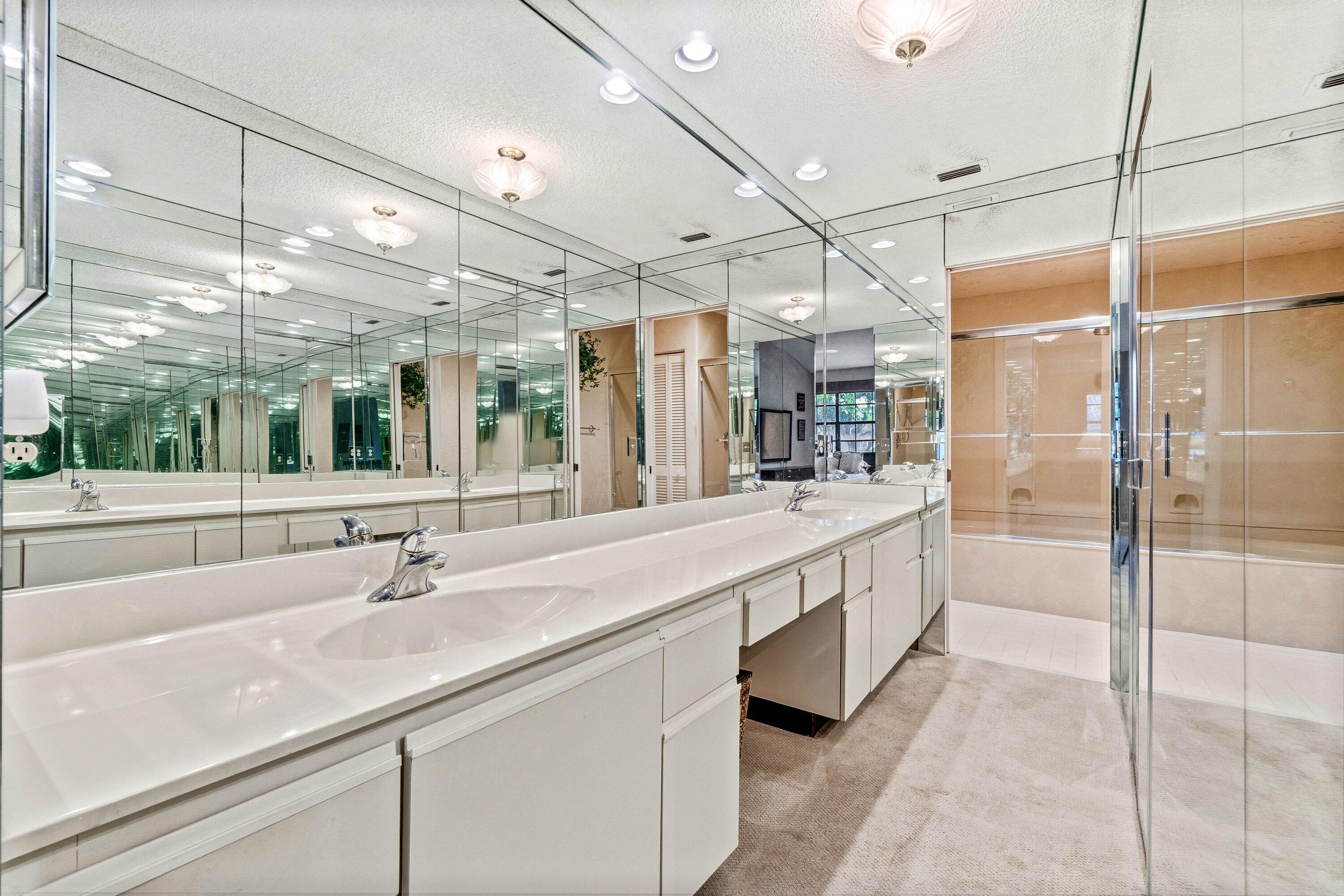 7759 La Mirada Drive Boca Raton, FL 33433 - Photo 23 of 37 a large white bathroom with a double vanity sink a mirror and a shower