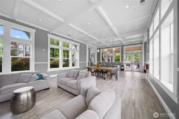 a living room with furniture and floor to ceiling windows