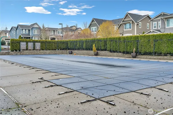 a view of a brick house next to a road with big building