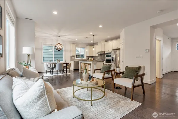 a living room with furniture and kitchen view
