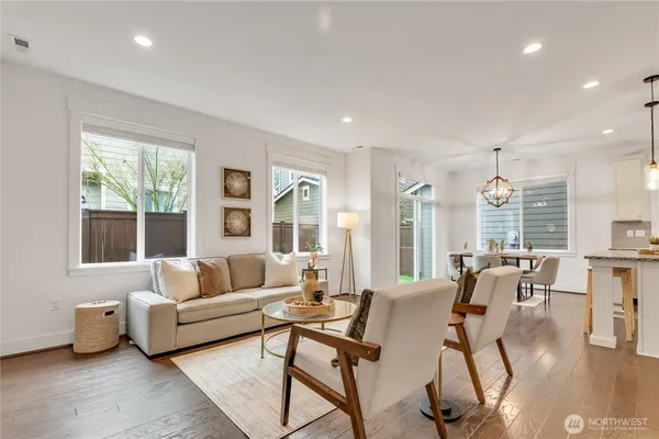 a living room with furniture and floor to ceiling windows