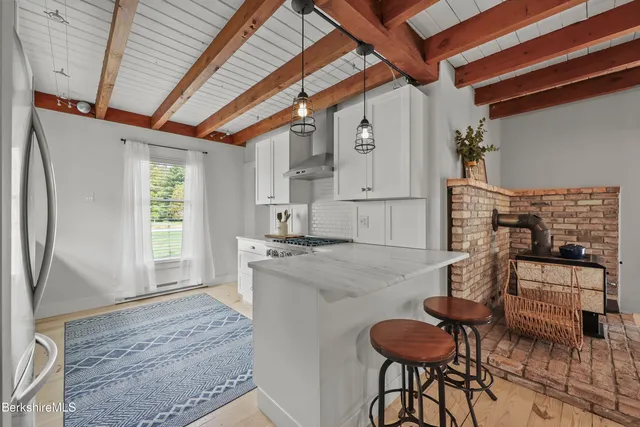 a kitchen with furniture and a fireplace