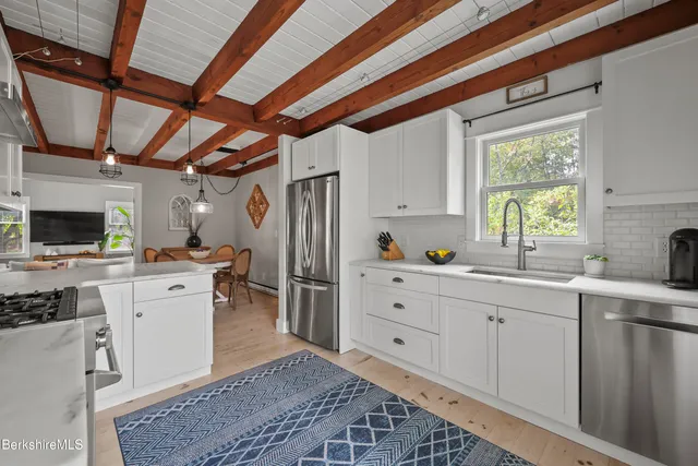 a kitchen with a sink a refrigerator and cabinets