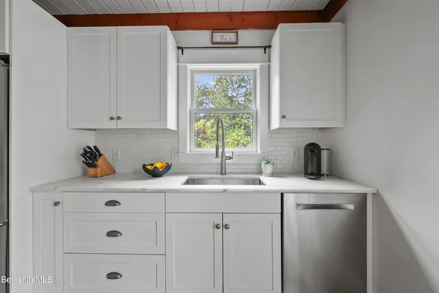 a kitchen with a sink cabinets and window