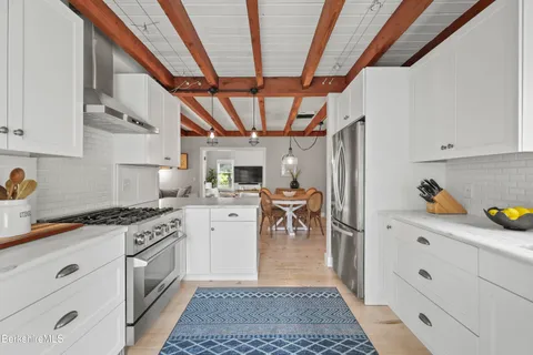 a kitchen with white cabinets and white appliances