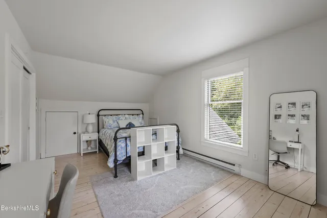 a bedroom with furniture and a window