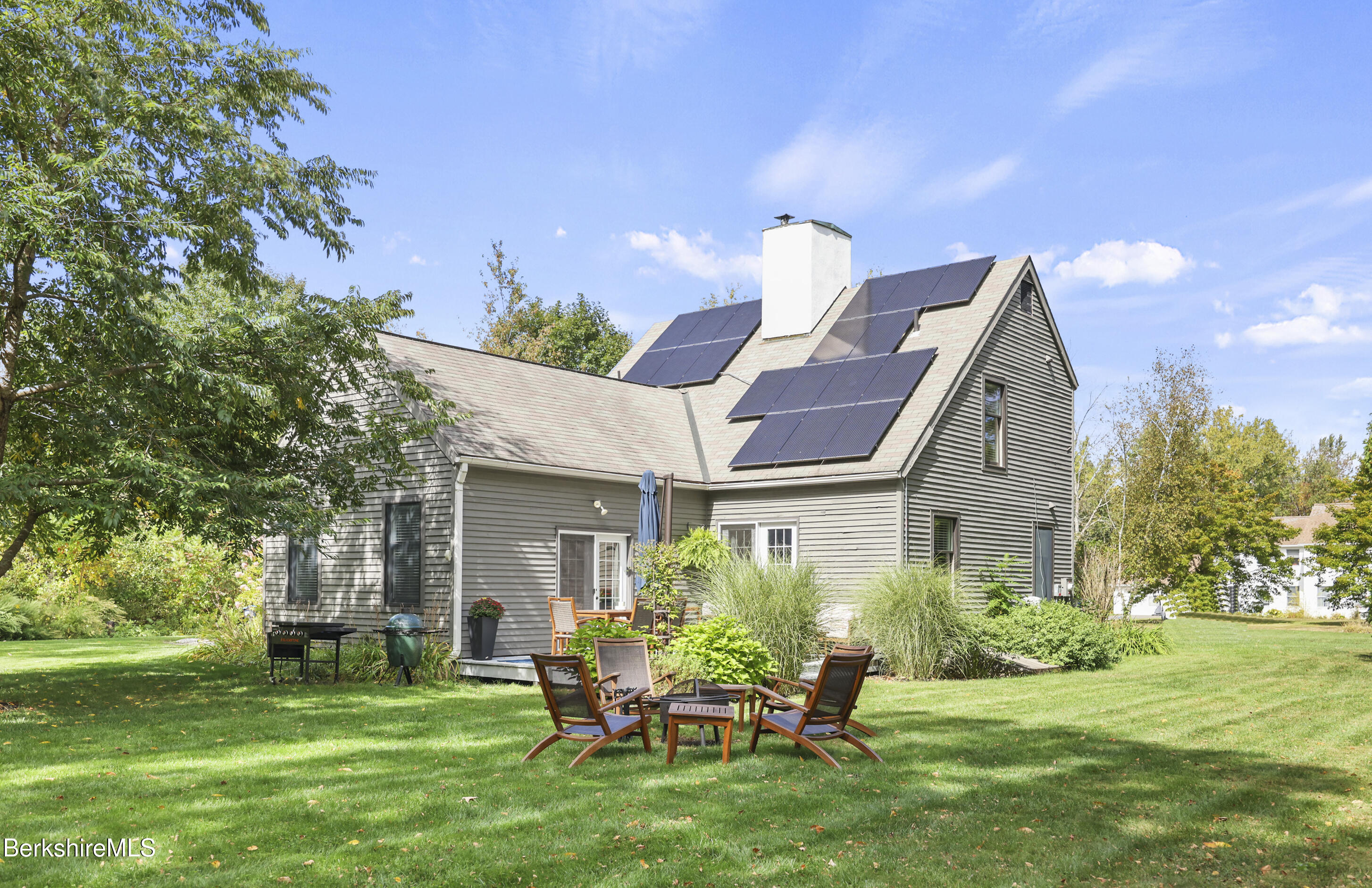 17 Iron Mine Road West Stockbridge, MA 01266 - Photo 38 of 49 a backyard of a house with a garden and barbeque oven