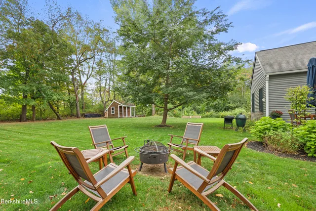 a view of a chair and table in the garden