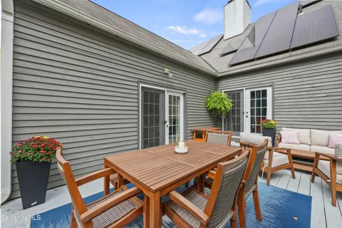 a view of a patio with table and chairs and potted plants