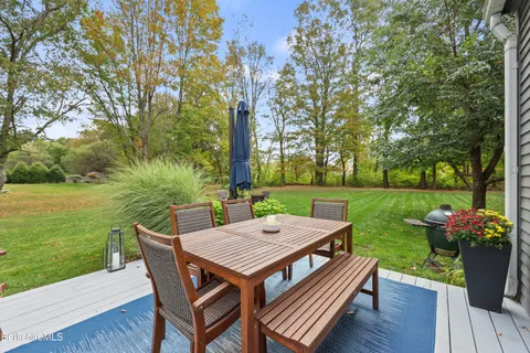 a backyard of a house with outdoor seating