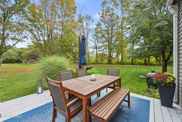 a backyard of a house with outdoor seating