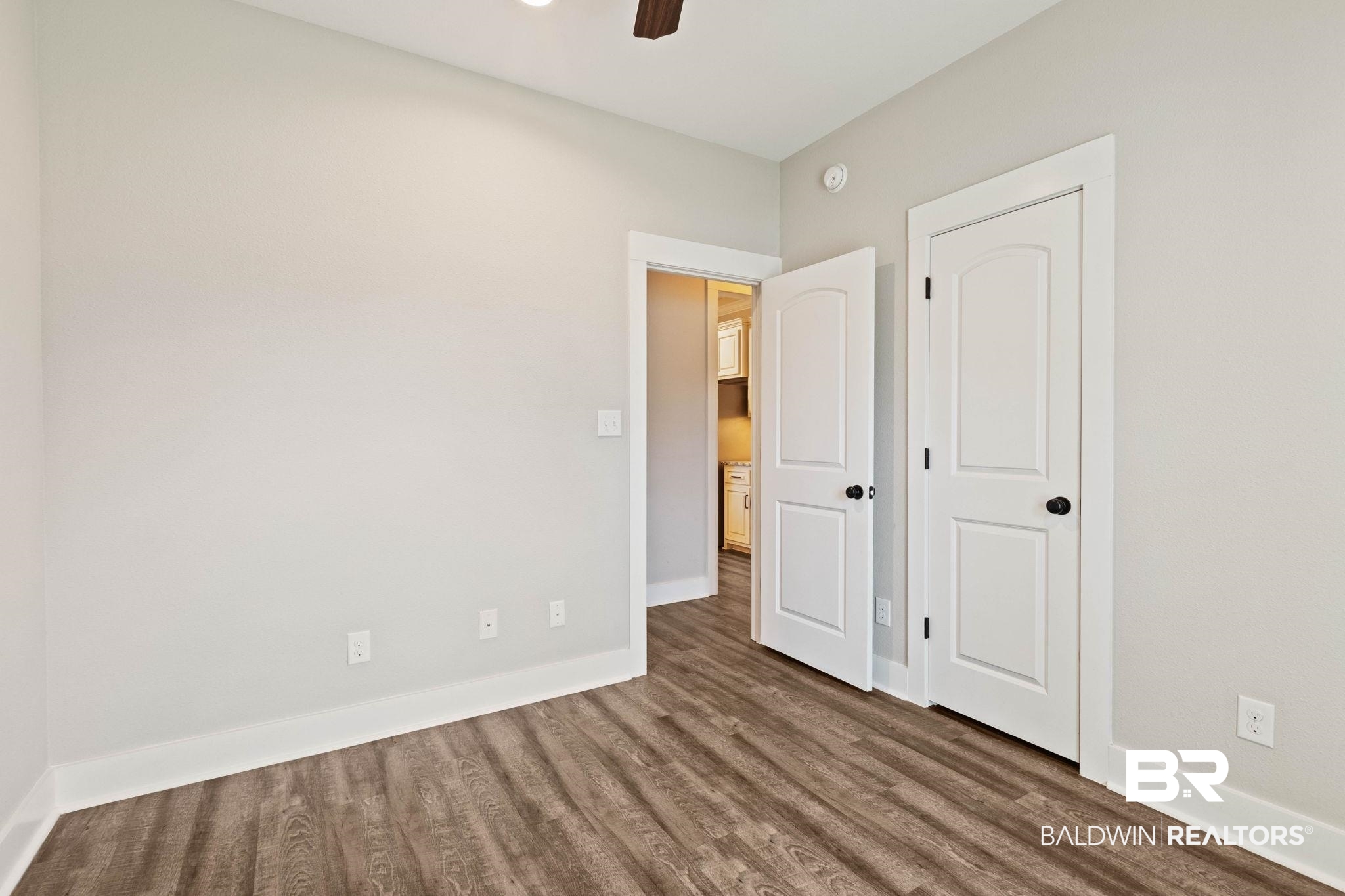 17376 Bankhead Boulevard Fairhope, AL 36532 - Photo 50 of 73 Unfurnished bedroom featuring dark wood-style floors, a ceiling fan, and a closet