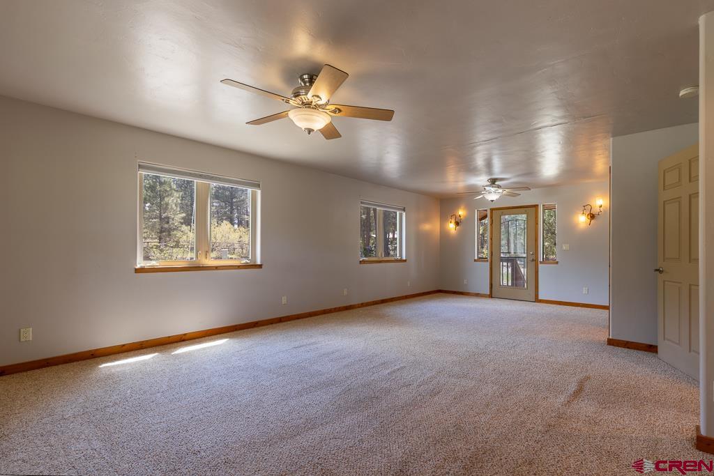 30 Stage Coach Road Bayfield, CO 81122 - Photo 11 of 36 an empty room with windows and fan
