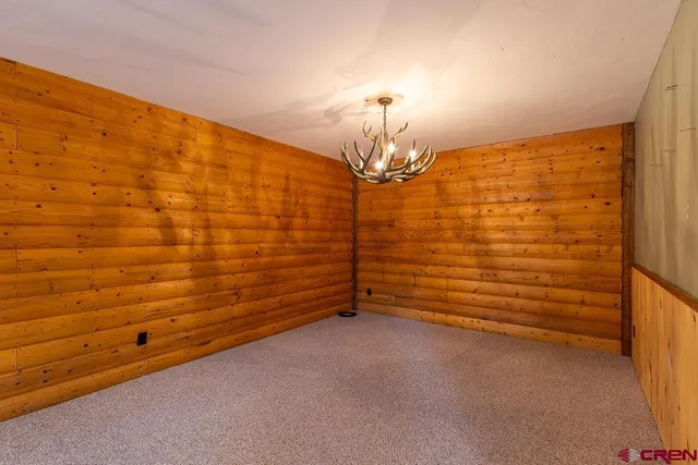 a view of a room with stairs and a chandelier fan