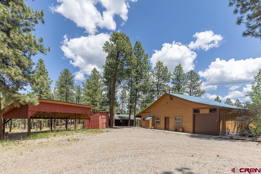 30 Stage Coach Road Bayfield, CO 81122 - Photo 22 of 36 a front view of a house with a yard and garage