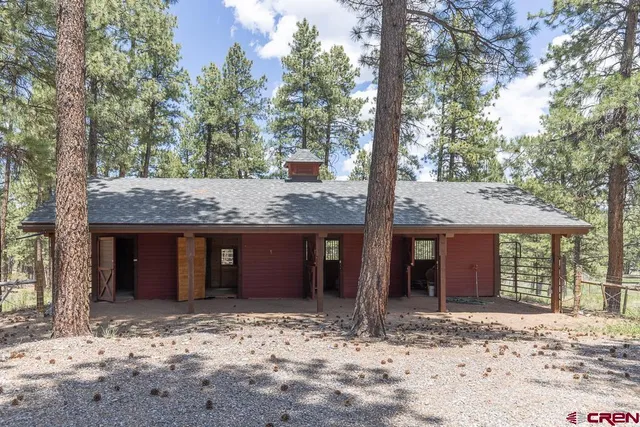a view of a house with a tree in front of it
