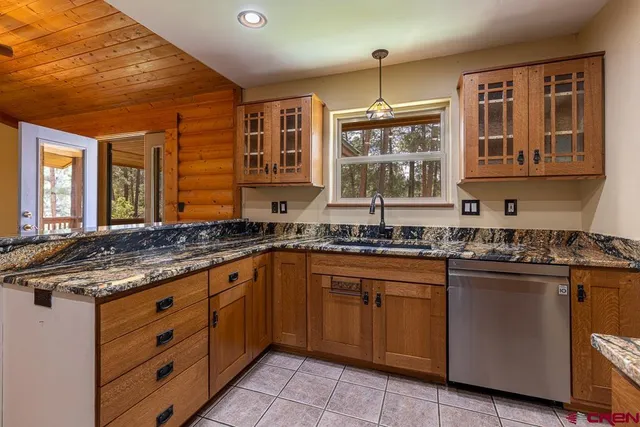 a kitchen with stainless steel appliances granite countertop a sink and stove top oven
