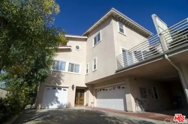 a view of a white building among the street