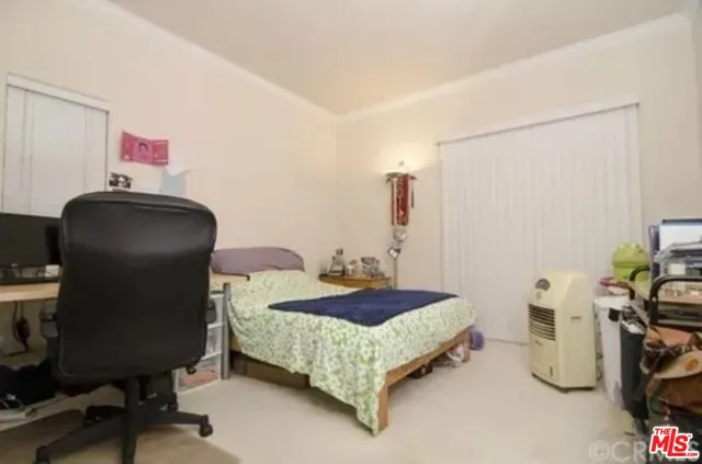 a bedroom with a bed and a chair