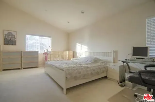 a bedroom with a bed and flat screen tv