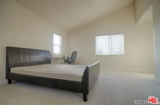 a bedroom with a bed chair and window