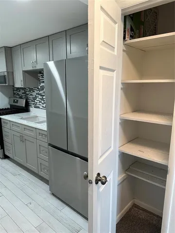 a kitchen with a refrigerator and a sink