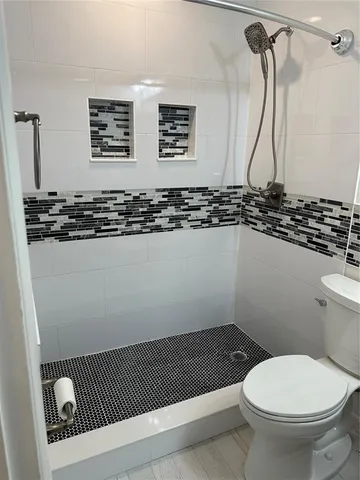 a bathroom with a sink a toilet and mirror