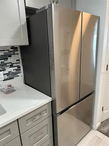 a kitchen with metallic refrigerator and stove