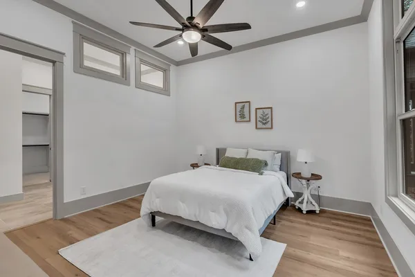 a bedroom with a bed and wooden floor