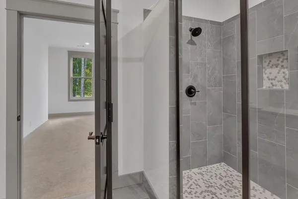 a bathroom with a glass shower door