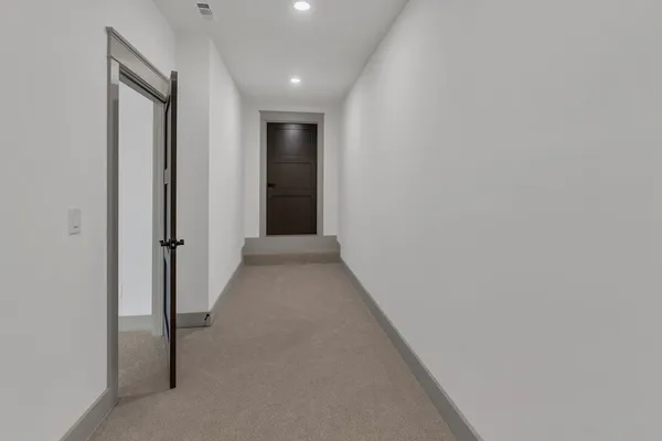 a view of a hallway with wooden shelves
