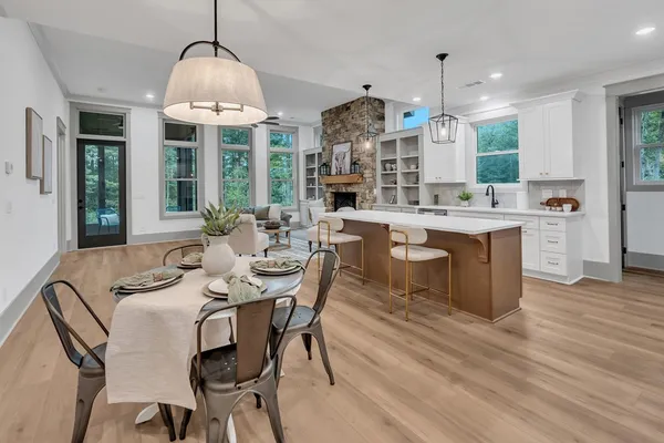 a view of a dining room with furniture wooden floor and chandelier