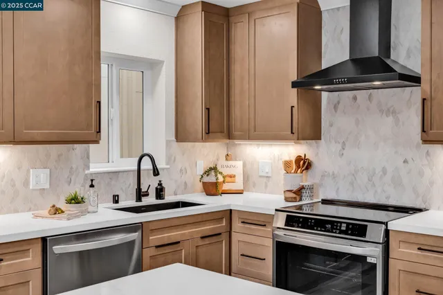 a kitchen with a sink stove and cabinets