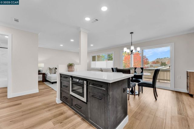 a kitchen with stainless steel appliances a table chairs and a chandelier