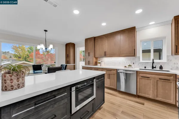 a kitchen with sink cabinets and wooden floor