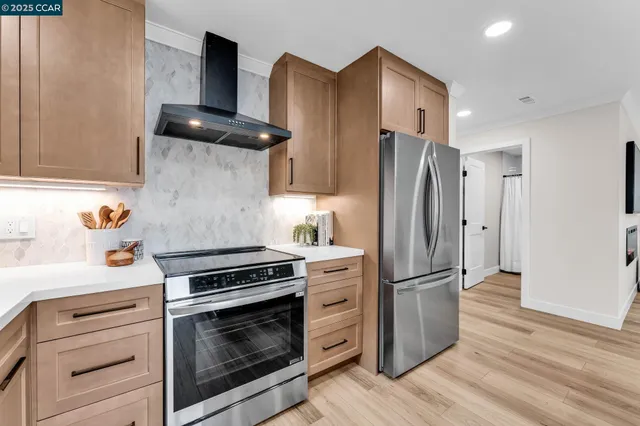a kitchen with granite countertop stainless steel appliances a counter space and cabinets