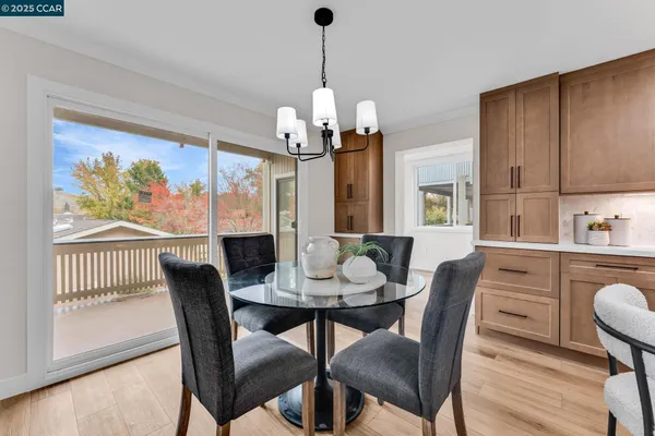 a view of a dining room with furniture wooden floor and a chandelier