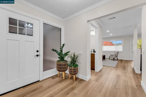 a hallway with wooden floor and furniture
