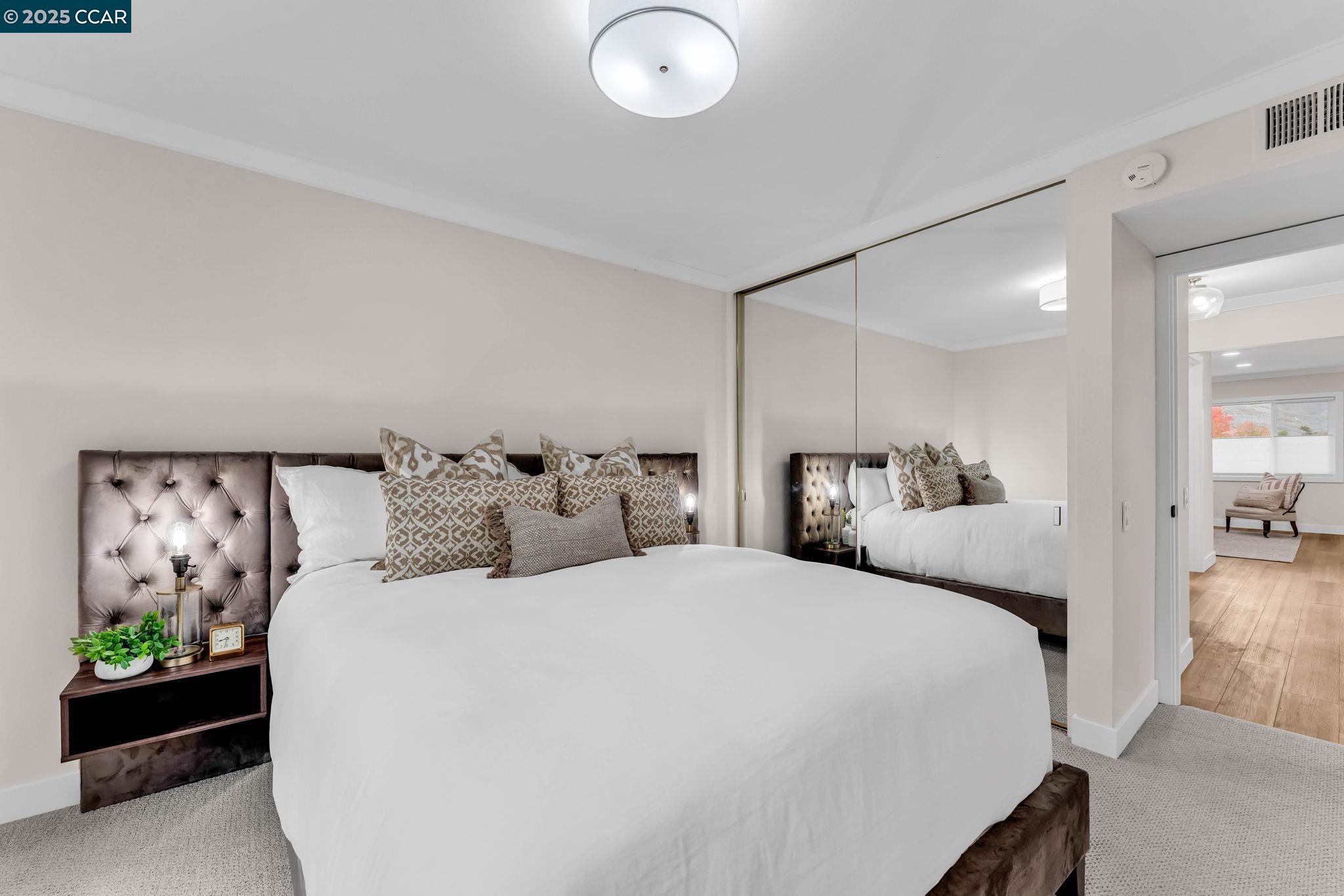 1216 Fairlawn Court, Unit 8 Walnut Creek, CA 94595 - Photo 32 of 49 a bedroom with bed and a painting on the wall