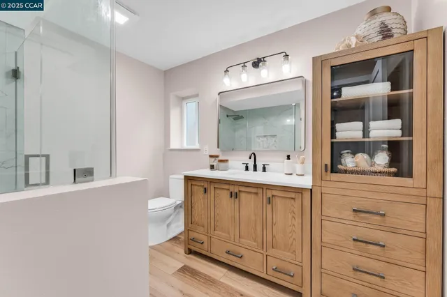 a bathroom with a sink a toilet and mirror