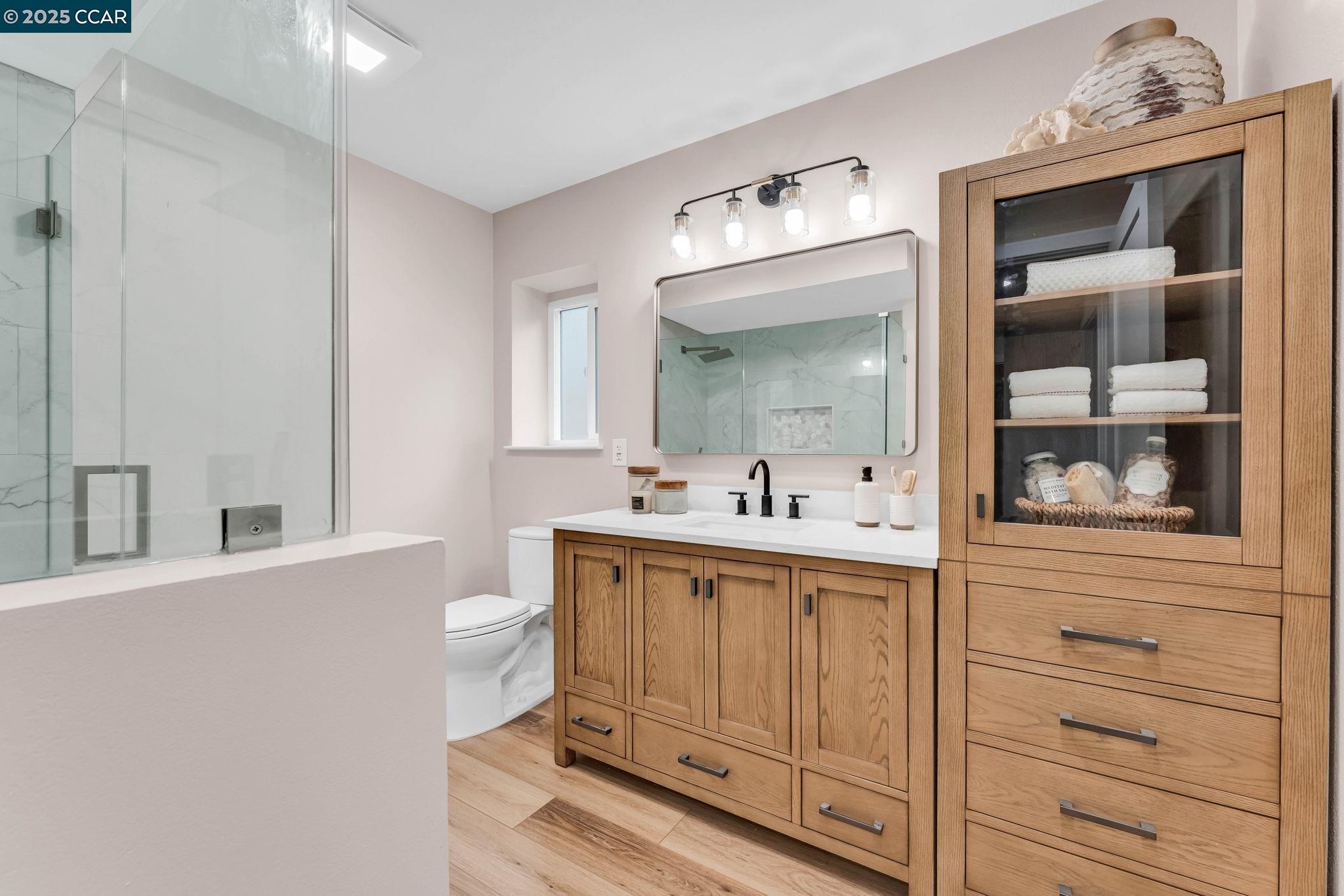 1216 Fairlawn Court, Unit 8 Walnut Creek, CA 94595 - Photo 34 of 49 a bathroom with a sink a toilet and mirror